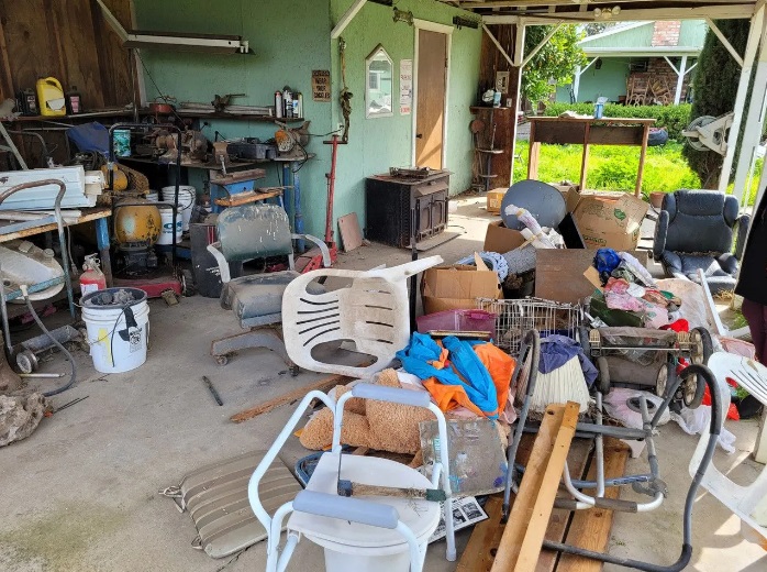 Eviction Cleanout Before - Abandoned belongings and furniture